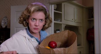 Movie still from “Honey, I Shrunk the Kids” (1989), directed by Joe Johnston – A woman holding a paper bag with an apple in it and an orange; Close Up shot, Over the shoulder angle