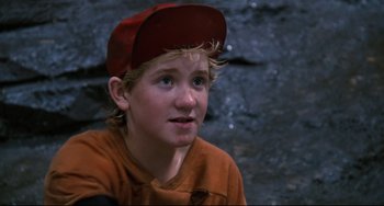 Movie still from “Honey, I Shrunk the Kids” (1989), directed by Joe Johnston – A young boy wearing a red hat and a brown shirt; Close Up shot, Low angle