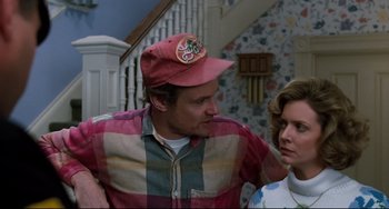 Movie still from “Honey, I Shrunk the Kids” (1989), directed by Joe Johnston – A man and woman in a room with a staircase in the background; Medium shot, Over the shoulder angle