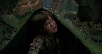 Movie still from “Honey, I Shrunk the Kids” (1989), directed by Joe Johnston – A young boy wearing glasses under an umbrella; Close Up shot, Low angle