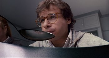 Movie still from “Honey, I Shrunk the Kids” (1989), directed by Joe Johnston – A man with glasses is looking at a frying pan; Close Up shot, High angle