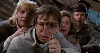 Movie still from “Honey, I Shrunk the Kids” (1989), directed by Joe Johnston – A group of people looking through a magnifying glass; Close Up shot, Low angle