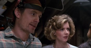 Movie still from “Honey, I Shrunk the Kids” (1989), directed by Joe Johnston – A man and a woman standing next to each other on a bus; Close Up shot, Low angle