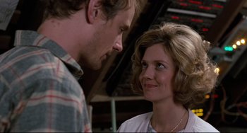 Movie still from “Honey, I Shrunk the Kids” (1989), directed by Joe Johnston – A man and a woman looking at one another; Close Up shot, Low angle