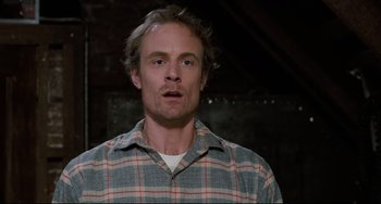 Movie still from “Honey, I Shrunk the Kids” (1989), directed by Joe Johnston – A man in a plaid shirt is looking at the camera; Close Up shot, Low angle