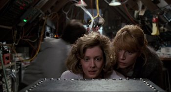 Movie still from “Honey, I Shrunk the Kids” (1989), directed by Joe Johnston – Two women are looking at the camera in a hangar; Medium shot, Low angle