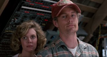 Movie still from “Honey, I Shrunk the Kids” (1989), directed by Joe Johnston – A man and a woman standing next to each other; Close Up shot, Low angle