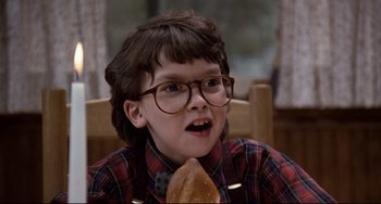 Movie still from “Honey, I Shrunk the Kids” (1989), directed by Joe Johnston – A young boy wearing glasses and eating a sandwich; Close Up shot, Low angle