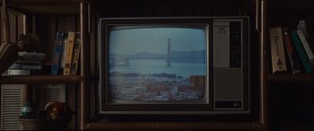 Movie still from “Us” (2019), directed by Jordan Peele – A television with a view of the golden gate bridge; Medium shot, High angle