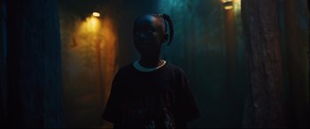 Movie still from “Us” (2019), directed by Jordan Peele – A young boy standing in a dark room; Medium shot, Low angle