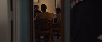Movie still from “Us” (2019), directed by Jordan Peele – A group of people sitting around a table; Medium shot, Over the shoulder angle