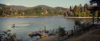 Movie still from “Us” (2019), directed by Jordan Peele – Three people standing on a dock near a body of water; Extreme Wide shot, High angle