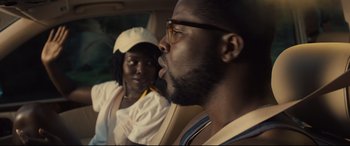 Movie still from “Us” (2019), directed by Jordan Peele – A man and a woman sitting in the back of a car; Close Up shot, Over the shoulder angle