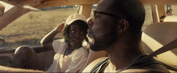 Movie still from “Us” (2019), directed by Jordan Peele – A man and a woman in a car on a road; Close Up shot, Over the shoulder angle