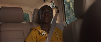Movie still from “Us” (2019), directed by Jordan Peele – A person sitting in a car holding a seat belt; Close Up shot, Over the shoulder angle