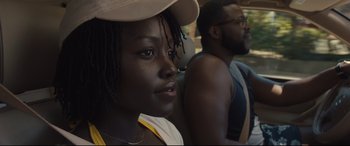Movie still from “Us” (2019), directed by Jordan Peele – A woman and a man are sitting next to each other; Close Up shot, Over the shoulder angle