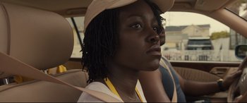 Movie still from “Us” (2019), directed by Jordan Peele – A woman with a hat sitting in a car; Close Up shot, Over the shoulder angle