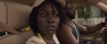 Movie still from “Us” (2019), directed by Jordan Peele – A person wearing a hat; Close Up shot, Over the shoulder angle