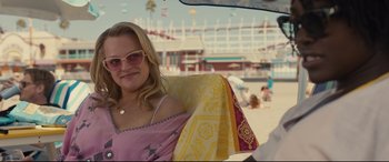 Movie still from “Us” (2019), directed by Jordan Peele – A woman sitting in a chair on the beach; Medium shot, Over the shoulder angle