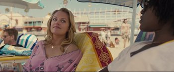 Movie still from “Us” (2019), directed by Jordan Peele – A woman sitting on the back of a vehicle; Close Up shot, Over the shoulder angle