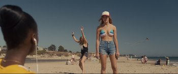 Movie still from “Us” (2019), directed by Jordan Peele – Two young women on the beach playing with a frisbee; Wide shot, Low angle