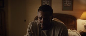 Movie still from “Us” (2019), directed by Jordan Peele – A person sitting in a room; Close Up shot, Over the shoulder angle