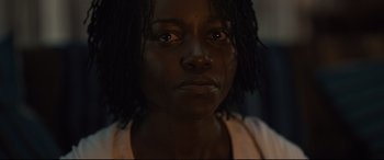 Movie still from “Us” (2019), directed by Jordan Peele – A person's eyes and face; Close Up shot, Over the shoulder angle