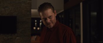 Movie still from “Us” (2019), directed by Jordan Peele – A person wearing a red shirt; Close Up shot, Low angle