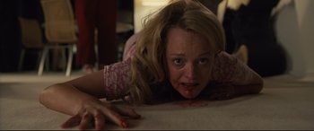 Movie still from “Us” (2019), directed by Jordan Peele – A woman laying on the ground with blood on her face; Medium shot, High angle