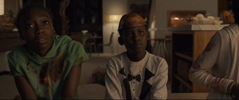 Movie still from “Us” (2019), directed by Jordan Peele – A young boy wearing an orange hard hat; Close Up shot, Over the shoulder angle