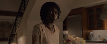 Movie still from “Us” (2019), directed by Jordan Peele – A person with a bandage on their arm; Close Up shot, Over the shoulder angle