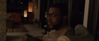 Movie still from “Us” (2019), directed by Jordan Peele – A person wearing glasses; Close Up shot, Over the shoulder angle