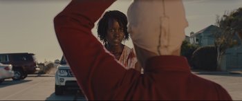Movie still from “Us” (2019), directed by Jordan Peele – A woman looking into a mirror while standing next to another woman; Close Up shot, Over the shoulder angle