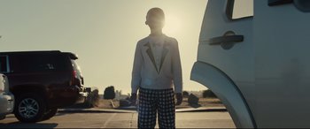 Movie still from “Us” (2019), directed by Jordan Peele – A person standing in front of an airplane in the sunlight; Wide shot, Low angle
