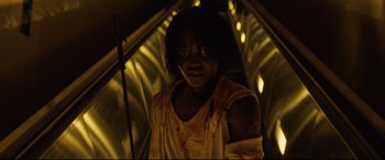 Movie still from “Us” (2019), directed by Jordan Peele – A man with a bandage on his arm is standing in a tunnel; Medium shot, Low angle