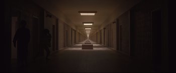 Movie still from “Us” (2019), directed by Jordan Peele – A long hallway with three benches in the middle of it; Extreme Wide shot, High angle