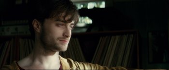 Movie still from “Horns” (2013), directed by Alexandre Aja – A person sitting in a room; Close Up shot, Over the shoulder angle