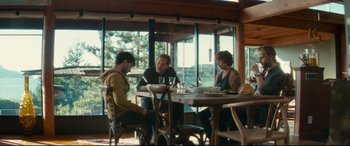 Movie still from “Horns” (2013), directed by Alexandre Aja – A group of people sitting around a table; Wide shot, Over the shoulder angle