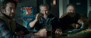 Movie still from “Horns” (2013), directed by Alexandre Aja – An older man sitting at a table drinking a beer; Medium shot, Over the shoulder angle