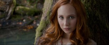 Movie still from “Horns” (2013), directed by Alexandre Aja – A beautiful young woman with long red hair and green eyes standing next to a tree; Close Up shot, Over the shoulder angle