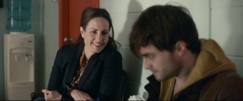 Movie still from “Horns” (2013), directed by Alexandre Aja – A woman sitting next to a man in front of a brick wall; Close Up shot, Over the shoulder angle