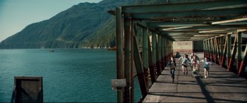 Movie still from “Horns” (2013), directed by Alexandre Aja – A person walking on a pier near a body of water; Extreme Wide shot, High angle