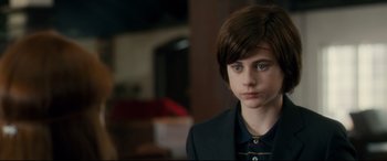 Movie still from “Horns” (2013), directed by Alexandre Aja – A young boy in a suit looking to his left; Close Up shot, Over the shoulder angle