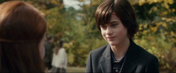 Movie still from “Horns” (2013), directed by Alexandre Aja – A young boy in a suit looks to his left; Close Up shot, Over the shoulder angle