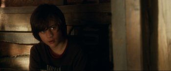 Movie still from “Horns” (2013), directed by Alexandre Aja – A young boy sitting in a dark room; Close Up shot, Over the shoulder angle