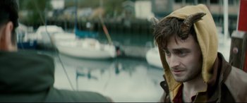 Movie still from “Horns” (2013), directed by Alexandre Aja – A young man holding onto a boat in the water; Close Up shot, Over the shoulder angle