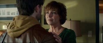 Movie still from “Horns” (2013), directed by Alexandre Aja – A woman in a green shirt is holding a man in a brown jacket; Close Up shot, Over the shoulder angle