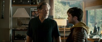 Movie still from “Horns” (2013), directed by Alexandre Aja – A man standing next to another man in a room; Medium shot, Over the shoulder angle