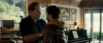 Movie still from “Horns” (2013), directed by Alexandre Aja – A man and a young man are talking in a room; Medium shot, Over the shoulder angle