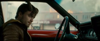 Movie still from “Horns” (2013), directed by Alexandre Aja – A man sitting in a car with a cigarette in his mouth; Close Up shot, Over the shoulder angle